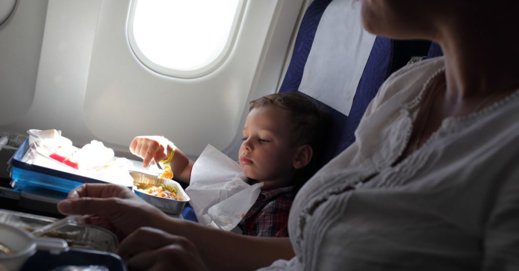 kid entertained on a plane