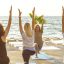 yoga on the beach - staying fit on holiday